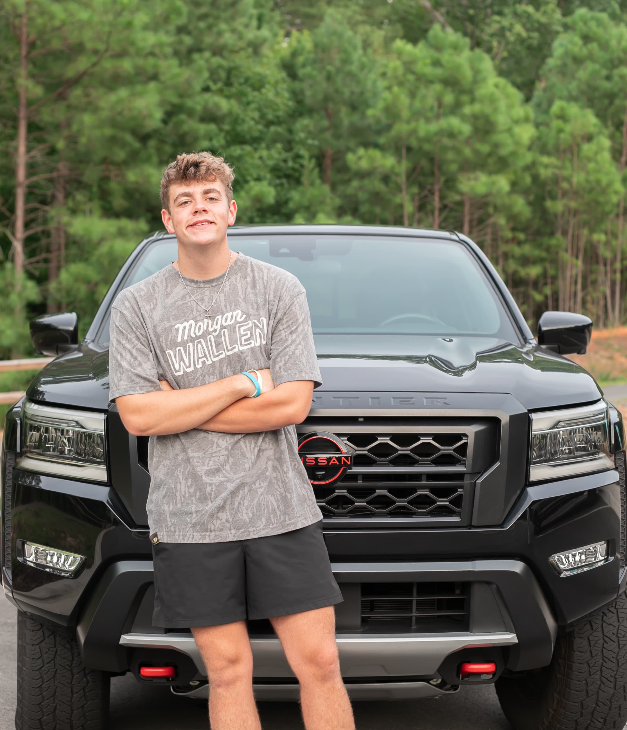 High school senior portrait in front of his truck