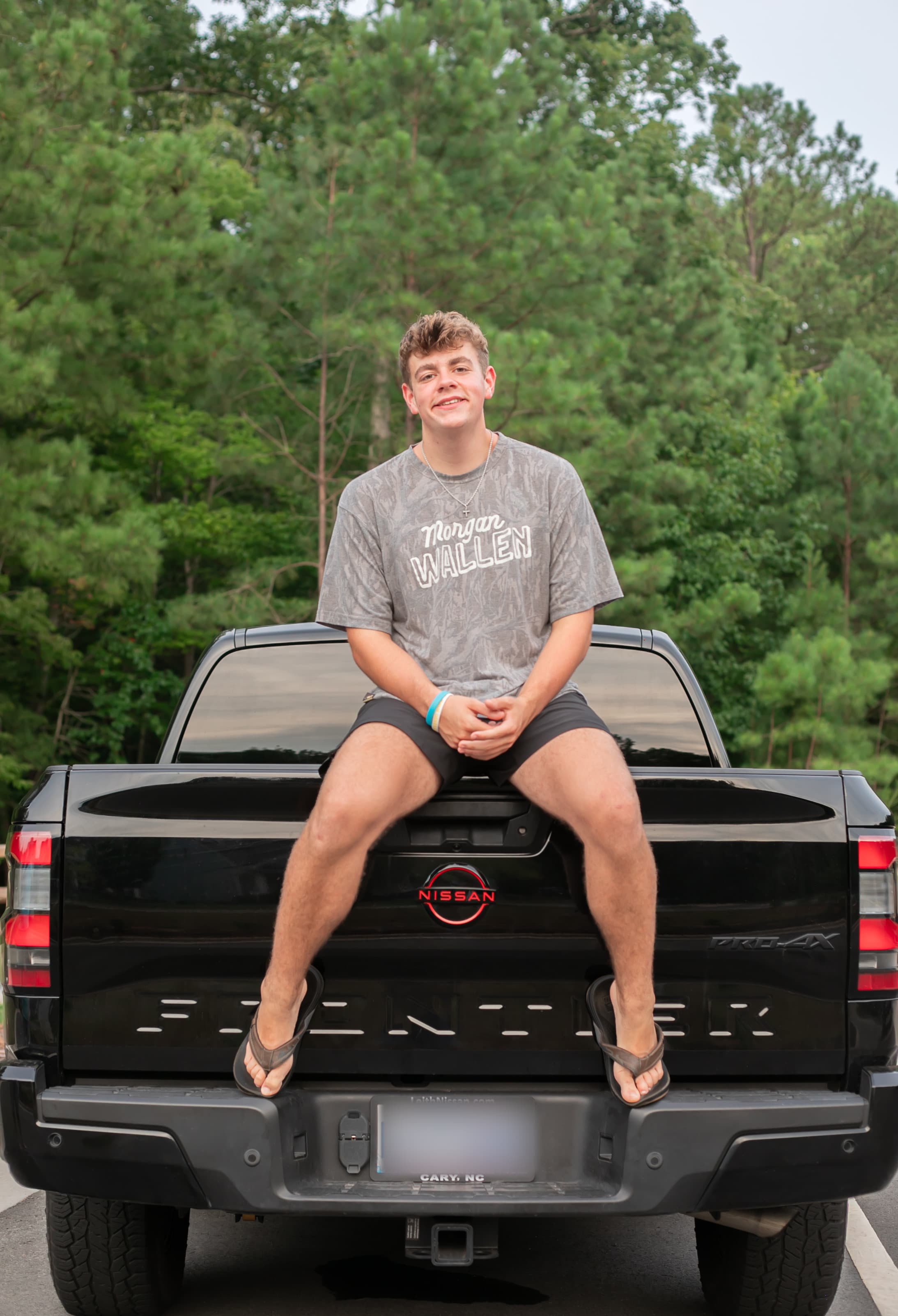 High school senior portrait seated on the tailgate